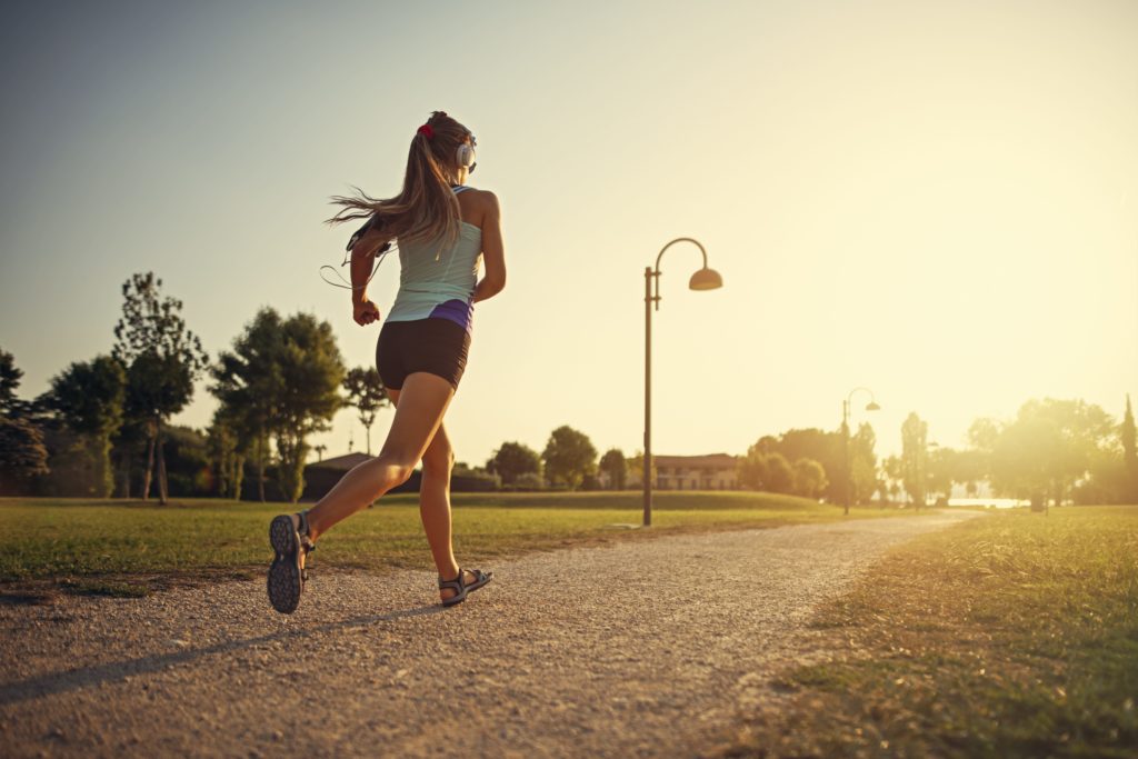 Young professional jogging on outdoor trail 