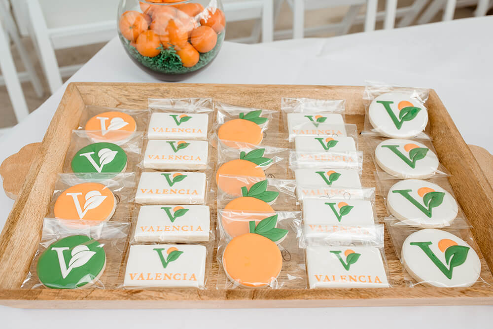 A welcome basket featuring cookies branded with the Valencia by Hillwood logo.